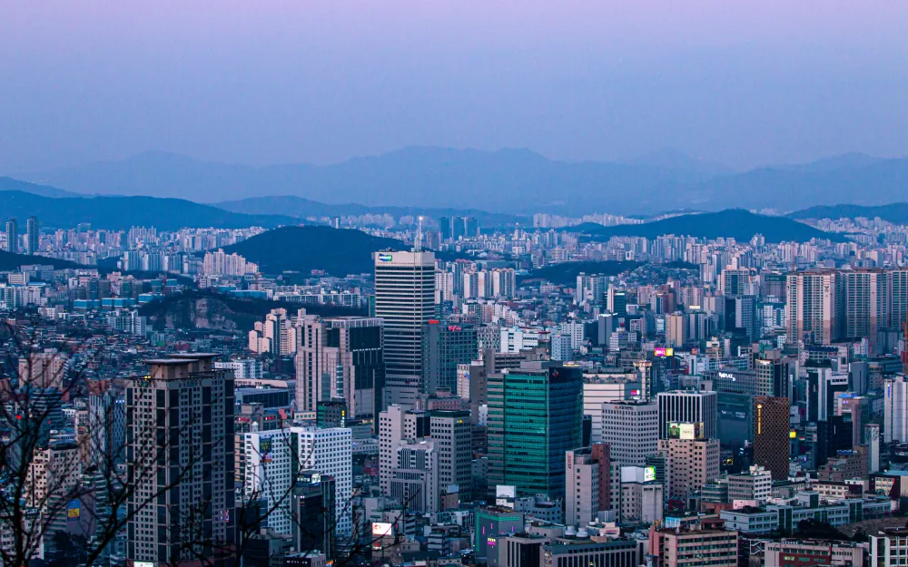 Urbanized district in Seoul with high-rise buildings and a busy street, illustrating a comprehensive guide on where to live in Seoul for international students.